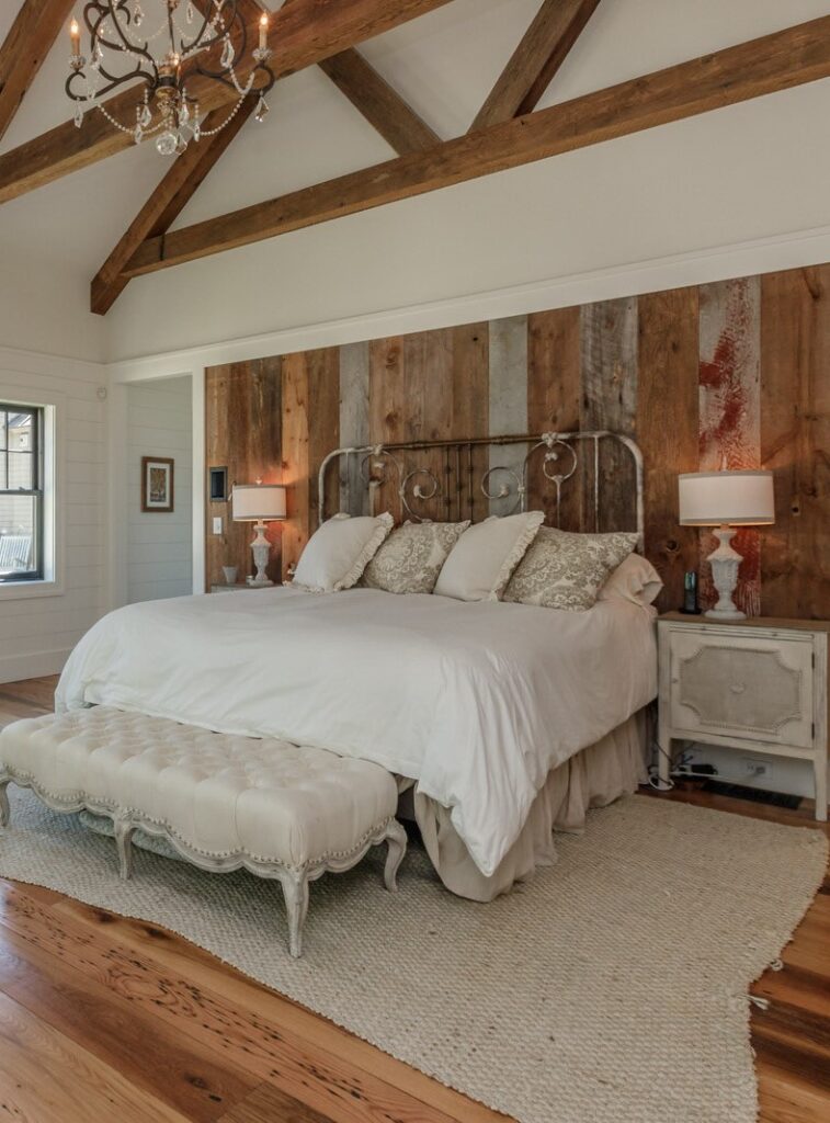 Wood Tones in Your Home | Bedroom with lots of mixed wood tones in flooring, beams, and decorative wall behind the bed.